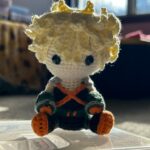 Small crocheted fan art doll of character Bakugo from My Hero Academia