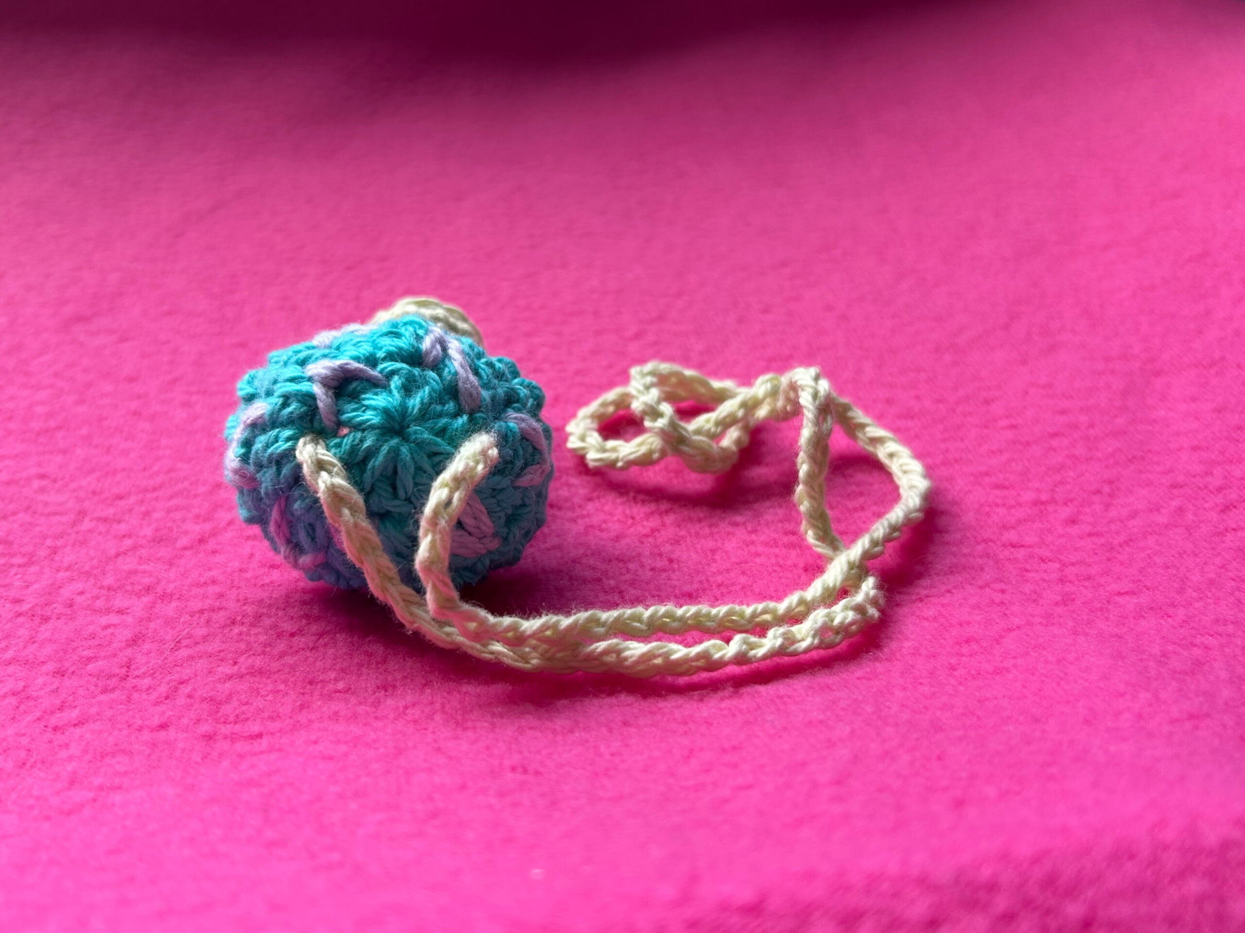 Close-up of strap threaded through the top of the mushroom cap